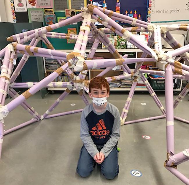 student shows his building structure